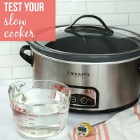slow cooker with a measuring cup of water and a food thermometer; text: How to test your slow cooker