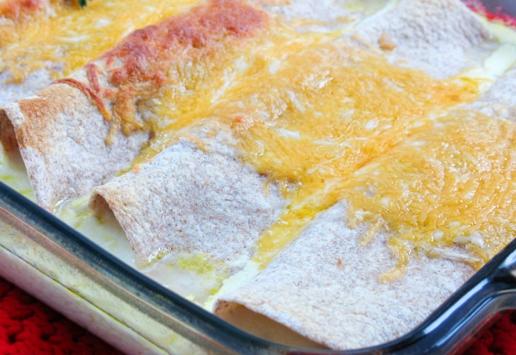 Pan of cooked enchiladad covered in melted cheese