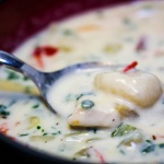 Chicken and gnocchi soup in a soup bowl with a spoon.