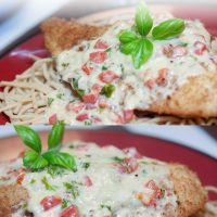 breaded cooked chicken breast smothered in a cream sauce with basil and red peppers; text Chicken in Basil Cream Sauce