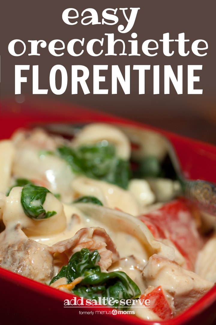 Red square bowl with orecchiette pasta, sliced onion, chopped bacon, roasted bell peppers, cooked spinach, and Alfredo sauce. There is a fork in the bowl. Text Easy Orecchiette Florentine Add Salt & Serve formerly menus4moms