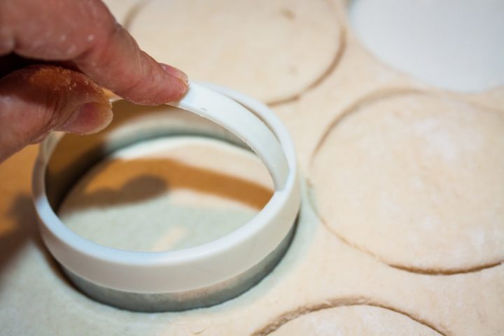 Biscuits being cut out of rolled dough