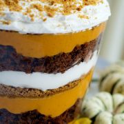 Image of layers of pumpkin filling, crushed gingersnaps, crumbled gingerbread, and whipped cream in a trifle bowl