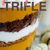 Image of layers of pumpkin filling, crushed gingersnaps, crumbled gingerbread, and whipped cream in a trifle bowl with text pumpkin Trifle - Add Salt & Serve (formerly Menus4Moms)