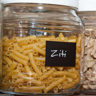 Glass jar filled with ziti with a chalkboard paint label and ziti written in chalk paint