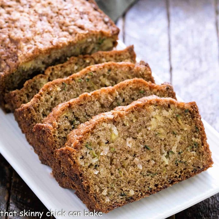 Sliced coconut zucchini bread on a platter.