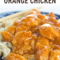Crockpot Orange Chicken on a bed of rice with chopsticks
