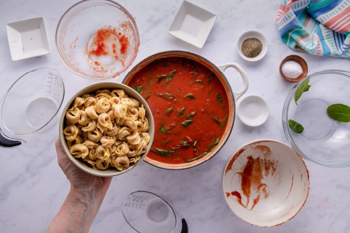 Adding tortellini to Tomato Spinach Tortellini Soup