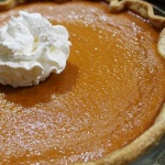 Baked pumpkin pie garnished with whipped cream