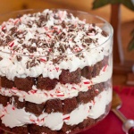 Layored peppermint trifle with serving spoon and Christmas decorations