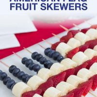 Blueberries, strawberries, and bananas threaded on bamboo skewers in the design of an American flag