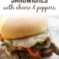 Close up photo of Steak Sandwich with Cheese and Peppers on a white plate; text Steak Sandwiches with Cheese & Peppers - Add Salt & Serve logo