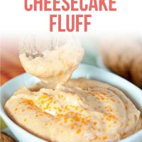 Bowl of Pumpkin Cheesecake Fluff garnished with orange crystalized sugar and a gingersnap for dipping.