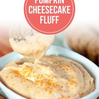 Bowl of Pumpkin Cheesecake Fluff garnished with orange crystalized sugar and a gingersnap for dipping.