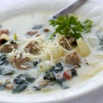 Bowl of soup with spinach, potatoes, bacon and cheese