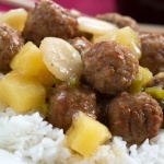 Meatballs, water chestnuts, and pineapple chunks in sauce over white rice, text Sweet and Sour Meatballs #quickandeasy
