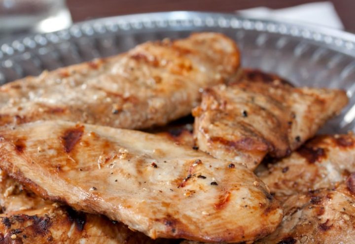 Grilled boneless skinless chicken breasts with a sesame marinade brushed on them and served on a Armetale platter