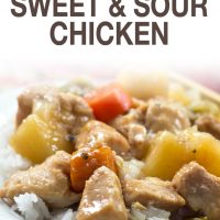 Chunks of cooked chicken, pinapple, carrots, and peppers served over white rice with text slow cocoker sweet and sour chicken