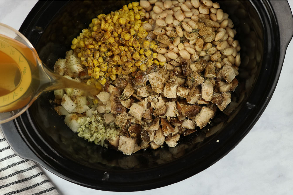 white chicken chili ingredients in slow cooker