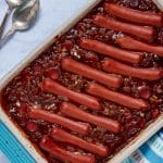 Baked franks and beans in a baking dish.
