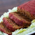 Sliced Taco Meatloaf on a white platter with lettuce garnish