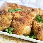 Breaded baked Chicken Parmesan drumsticks garnished with parsley