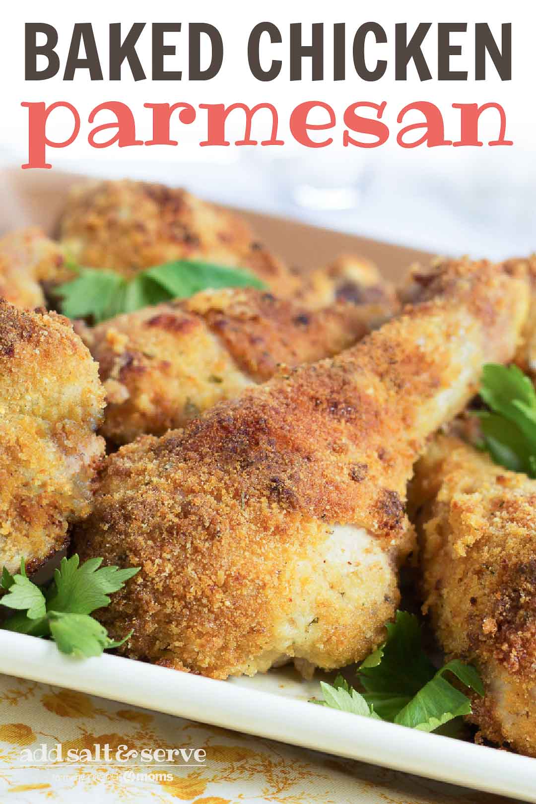 Crispy Baked Chicken Parmesan drumsticks served hot and ready to eat, garnished with fresh herbs.