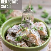 Bowl of potato salad garnished with parsley with a fork and text Best Ever Red Potato Salad - Add Salt & Serve logo