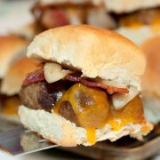 Hawaiian roll with meatballs, melted cheddar cheese, bacon, and sautéed onions