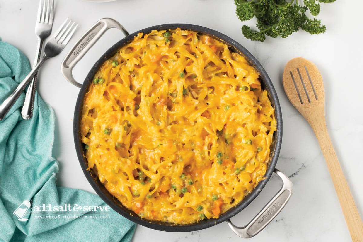 baked cheesy noodle casserole in a skillet.