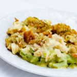 Chicken and broccoli with sauce and bread topping on a white plate