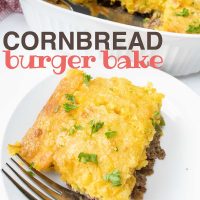 Cornbread Burger Bake in a white casserole dish. One piece is cut out and sitting on a white plate next to the casserole. There is a spatula in the casserole dish and a fork on the plate. Text is Cornbread Burger Bake Add Salt & Serve formerly Menus4Moms