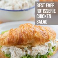 Chicken salad and lettuce on a croissant, all on a white plate. In the background is a bowl of chicken salad and more croisssants. Text is Best Ever Rotisserie Chicken Salad - Add Salt & Serve logo