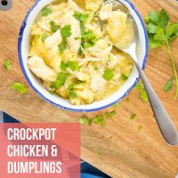 overhead view of a bowl of chicken and dumplings garnished with parsley in a bowl on a cutting board with a spoon serving a portion and text Easy Crockpot Chicken & Dumplings - Add Salt & Serve logo