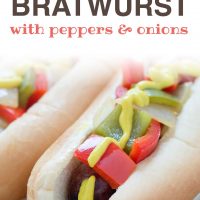 Bratwurst on a hotdog bun with mustard, diced red and green bell peppers and diced onions; text Grilled Bratwurst with Peppers and Onions Add Salt & Serve formerly Menus4Moms