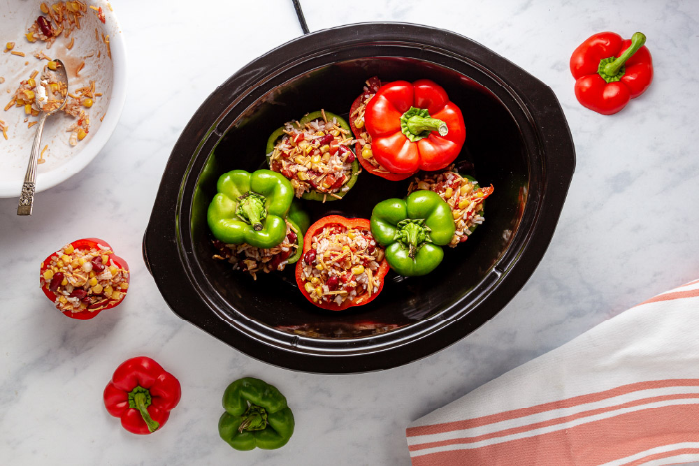 Easy Slow Cooker Southwestern Stuffed Peppers with Cheese in slow cooker before cooking