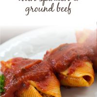 White plate with 3 jumbo pasta shells stuffed with beef and covered with spaghetti sauce, garnished with parsley; text Stuffed Shells with Spinach & Ground Beef - Add Salt & Serve logo
