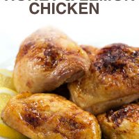 Four pieces of baked chicken on a white plate with lemon slices; text Baked Honey & Lemon Chicken - Add Salt & Serve logo