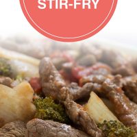 Cooked strips of beef with onions, brocolli florets, diced tomatoes, and mushrooms on a bed of rice; text Beef Vegetable Stir-fry - Add Salt & Serve logo