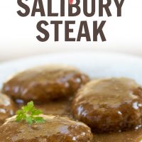Hamburger patties topped with brown gravy on a white plate with text Simple Salisbury Steak Add Salt & Serve