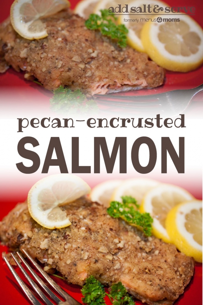 Pecan crusted salmon on a red plate with a fork, garnished with lemon slices and sprigs of parsley; text pecan-encrusted salmon add salt & serve formerly menus4moms