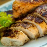 Sliced chicken breast on a white plate.