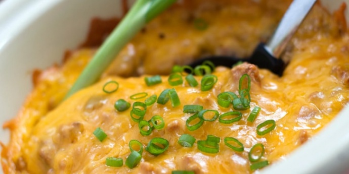 South of the Border Casserole in a white bowl with a serving spoon.