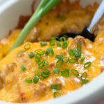 South of the Border Casserole in a white bowl with a serving spoon.