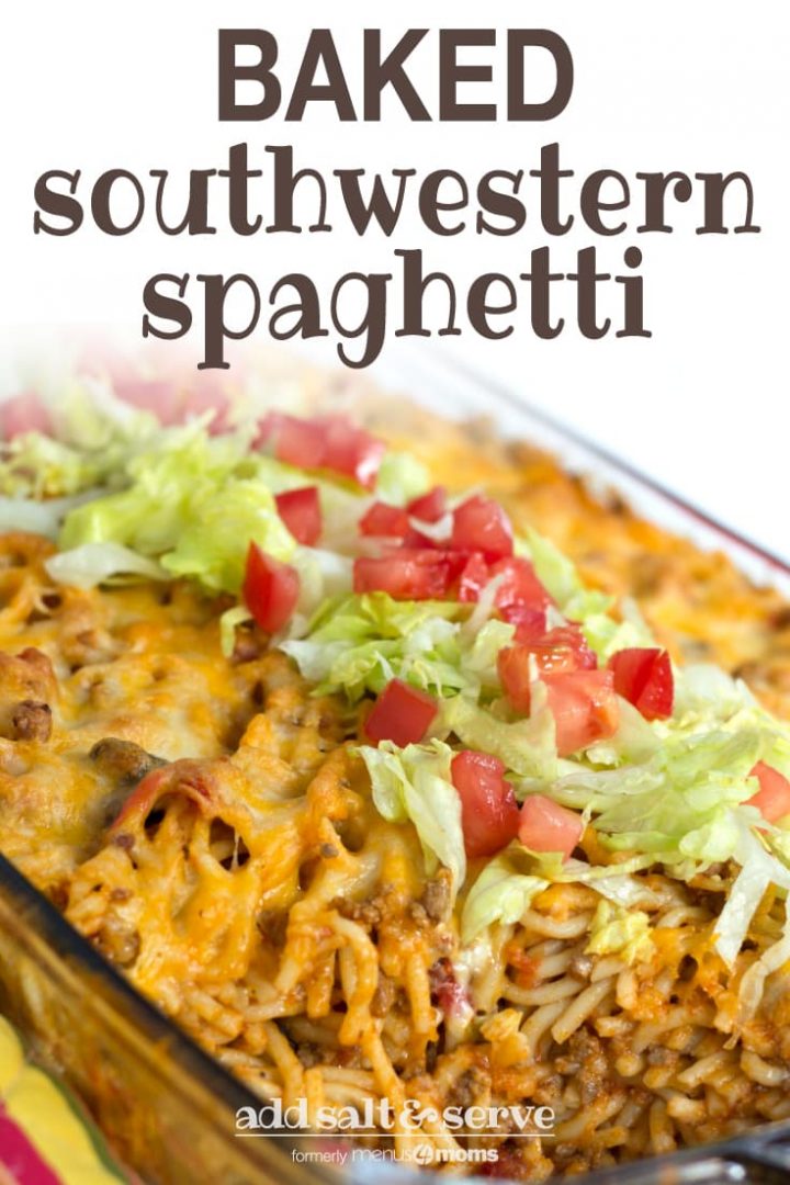 Clear casserole dish with spaghetti noodles, ground beef, and melted cheese, topped with shredded lettuce and diced tomatoes. Text baked southwestern spaghetti add salt & serve formerly menus4moms