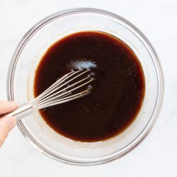 Large bowl of soy marinade being whisked