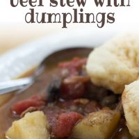 White bowl of beef stew with two dumplings on top. Stew consists of brown broth, diced beef, chopped potatoes, and stewed tomatoes. There is a spoon in the bowl on the left side. Text savory beef stew with dumplings add salt&serve, formerly menus4moms.