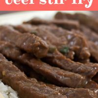 Sliced steak with a sauce on a bed of rice with chopsticks in the foreground. Text mongolian beef stir fry add salt & serve formerly menus4moms