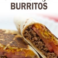 A burrito with ground beef, tomato slices, and melted cheese, cut in half on a white plate. Text toasted cheeseburger burritos add salt & serve formerly menus4moms