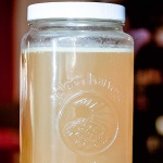 Large jar of chicken stock with a layer of fat at the top